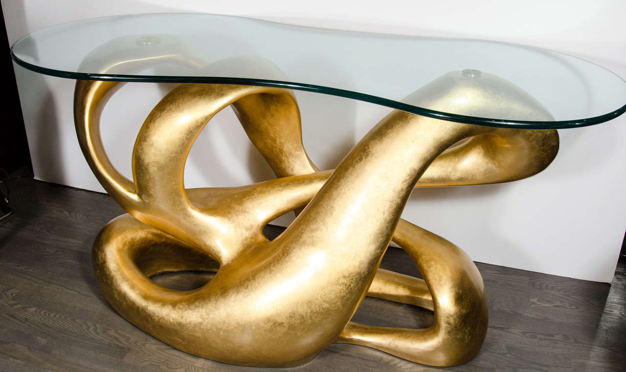 Considered one of Duquette's most inspired works, the Biomorphic Console was originally designed for the Charles and Palmer Ducommun Bel Air residence in the 1960s.

Impeccably recreated by Baker, the console is cast in resin in three separate