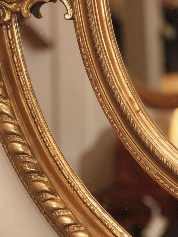 A Fine Pair of Antique Oval Carved Giltwood and Gesso Mirrors For Sale 5