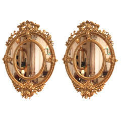 A Fine Pair of Antique Oval Carved Giltwood and Gesso Mirrors