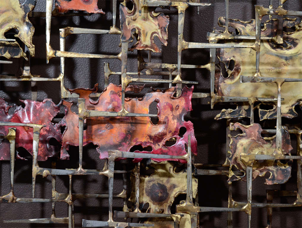 This wall Sculpture by Noted artist Silas Seandel is a variation of dimensions.He called it the Colorado wall sculpture. It is the first wall sculpture that he did and it is made of copper,brass,bronze,bronze welded steel nails creating a three