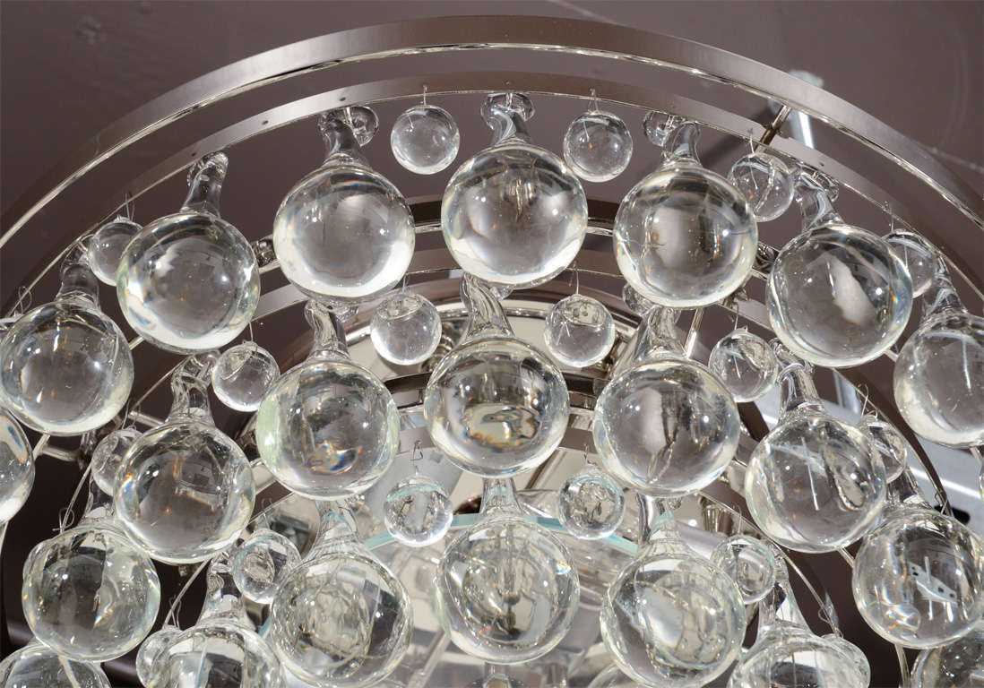 Circular flush mount ceiling light/<br />
chandelier with three tiers of large<br />
blown crystal tear drop pendants<br />
and a nickel frame and fittings.<br />
Also has a center glass plate<br />
detail and fitted with four <br />
lights.