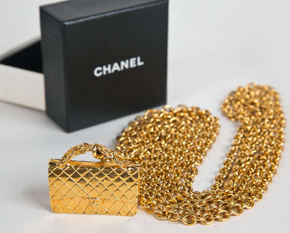 funkfyinders.com is pleased to present this circa 1980s chanel piece. it features the house's signature 'flap bag' pendant: complimenting the necklace or dangle enhancing the belt. the petite 'flap bag' is detailed to-a-t with a 'cc' on the purse