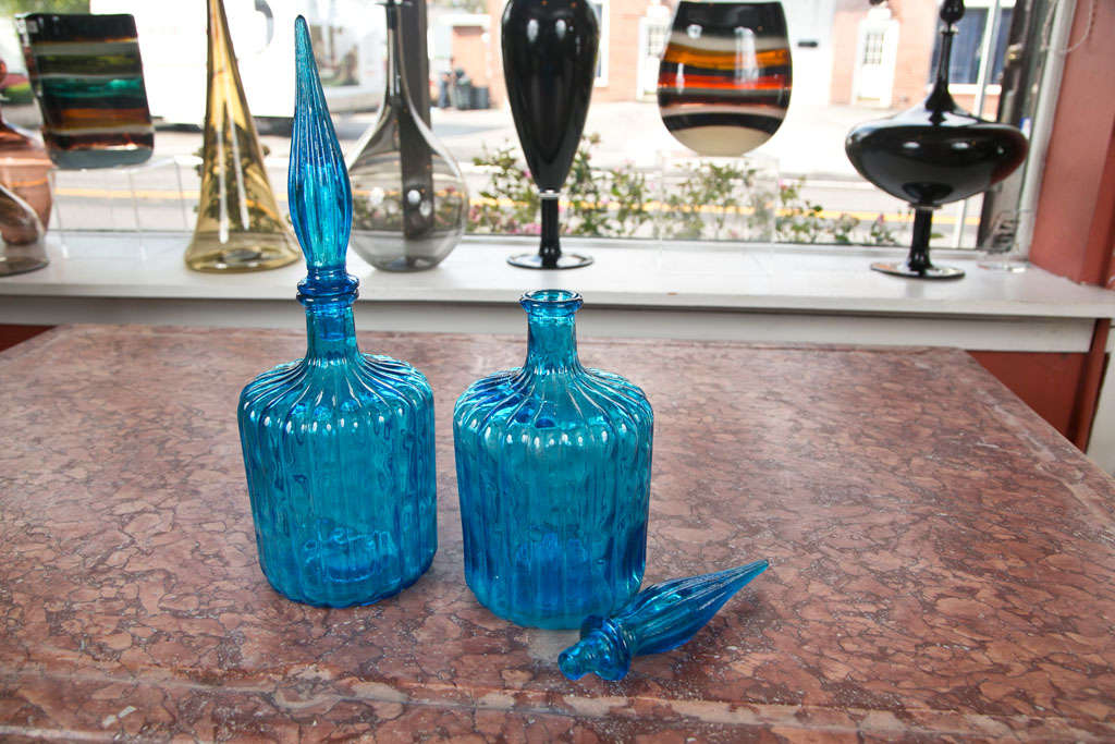 A striking tone of aqua blue blown glass decanters with stoppers.