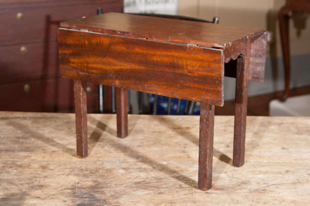A rare salesman sample of an American hepplewhite mahogany dropleaf table.