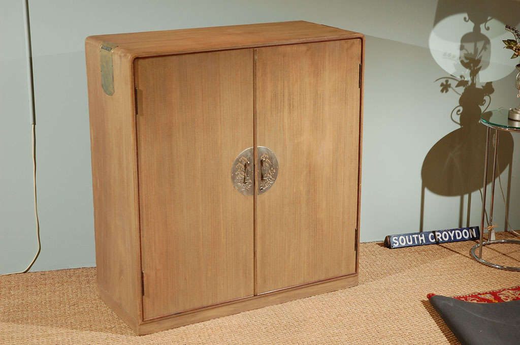Kimono Tansu of the Taisho period, 1912-1926.   Lightweight kiri wood with simple doors and sturdy pullout drawers for storing folded kimonos or clothing, with 2 closed drawers below. Graceful curves and light metal work. Shows art deco influence of