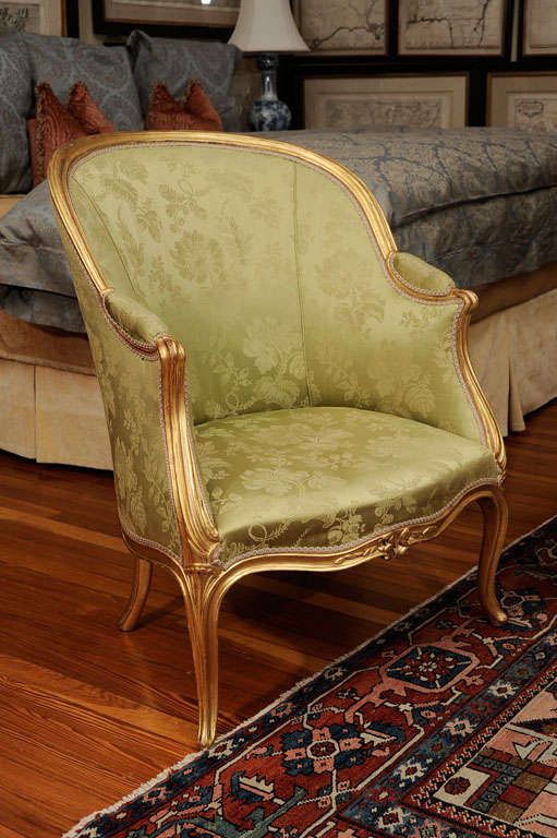 The curved molded crest rail leading to padded arms above a serpentine-fronted seat, with blossom-carved apron on cabriole legs terminating in slight scroll toes; upholstered in green silk damasks.