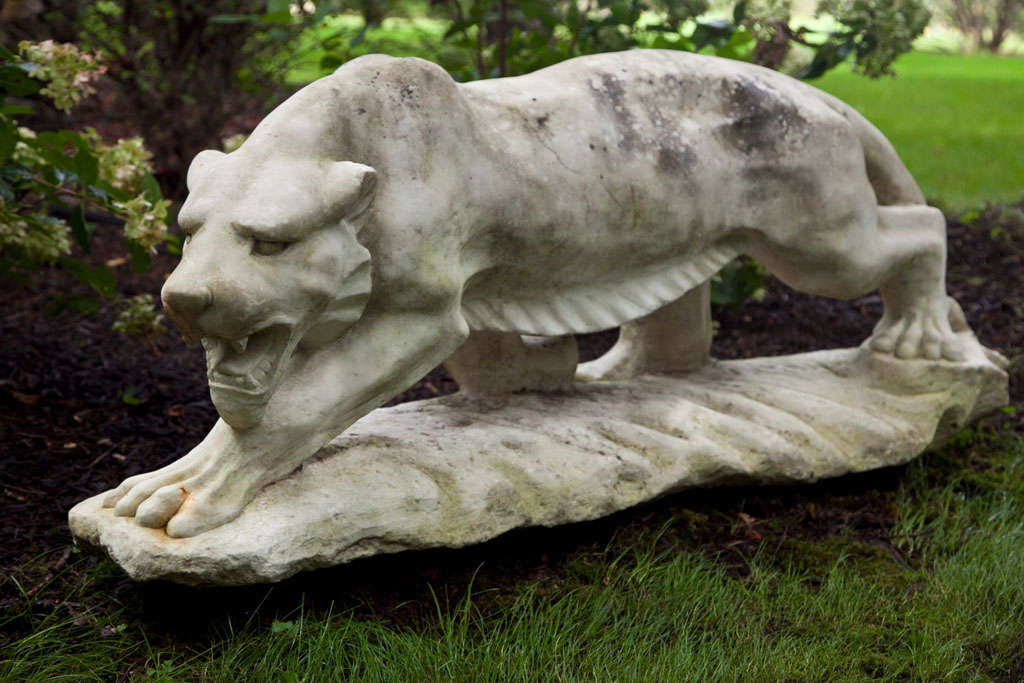 An exceptional carved marble figure of a tiger, captured in mid-stride and on the hunt, with stylized articulated musculature.