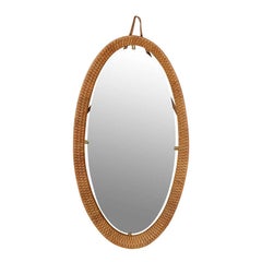 A Oval Rattan and Brass Mirror Frane and Mirror.