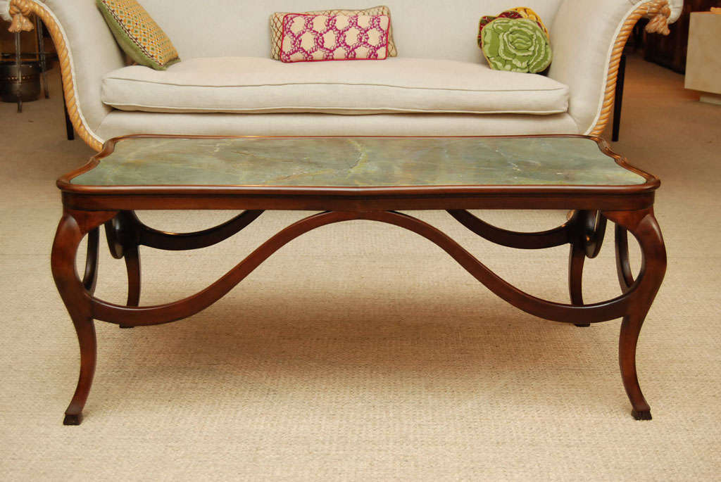 Here is a beautiful Art Nouveau coffee table in a rich walnut finish and a custom marble top. The smooth curves are elegant and luxurious.