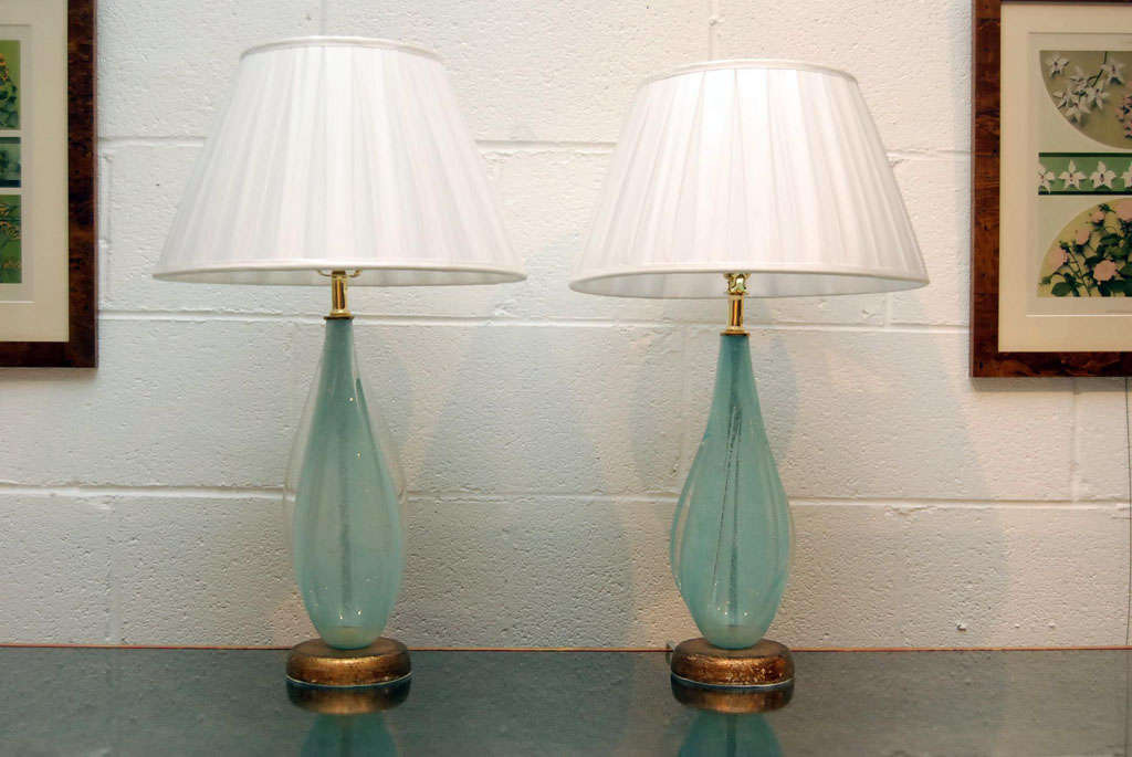 Here is a beautiful pair of pale blue Murano glass lamps.<br />
The swirl shape is organic and the glass has clear flecks.<br />
Very sweet, these would make great bedside or vanity lamps.