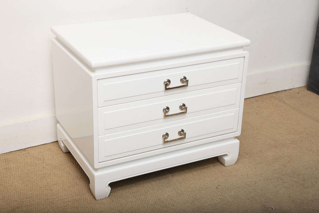 BEAUTIFULL PAIR OF SOLID WOOD NIGHTSTANDS , COMODES FROM THE 1960,S , THESE HAVE BEEN REFINISHED IN A HI-GLOSS WHITE. THEY RETAIN THE ORIGINAL LINEN TOP .ALL THE HARDWARE HAS BEEN RE-NICKEL PLATTED.