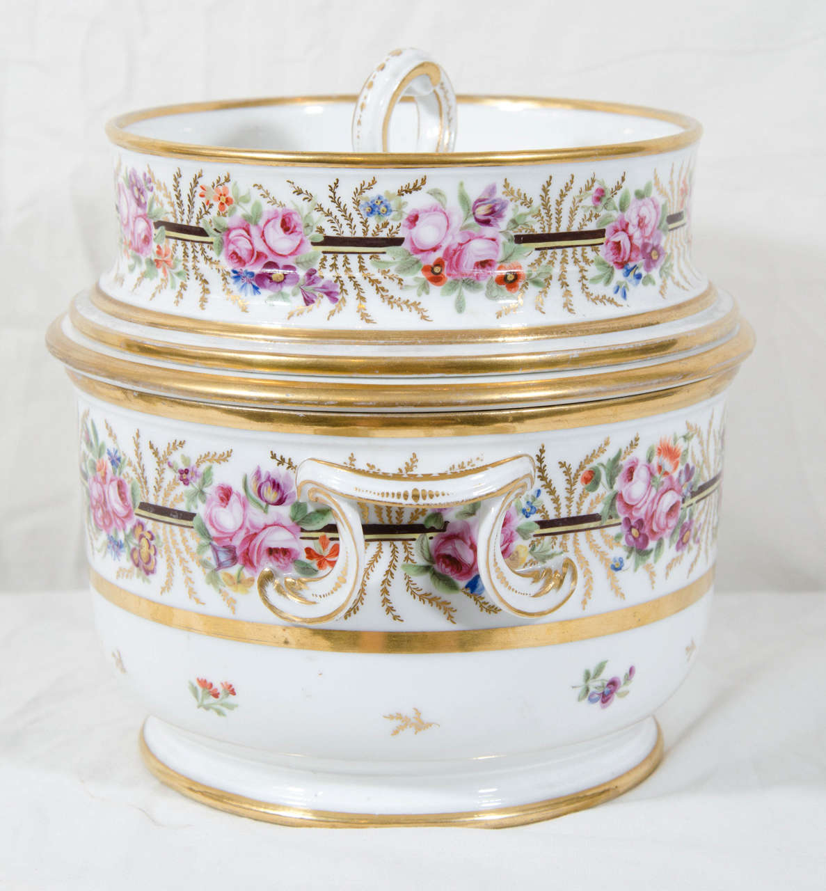 A pair of 18th century French ice pails beautifully painted with bouquets of roses and bands of gilt.
Ice pails are traditionally placed on the sideboard in the dining room.
In the 18th and early 19th century they were used to create iced cream