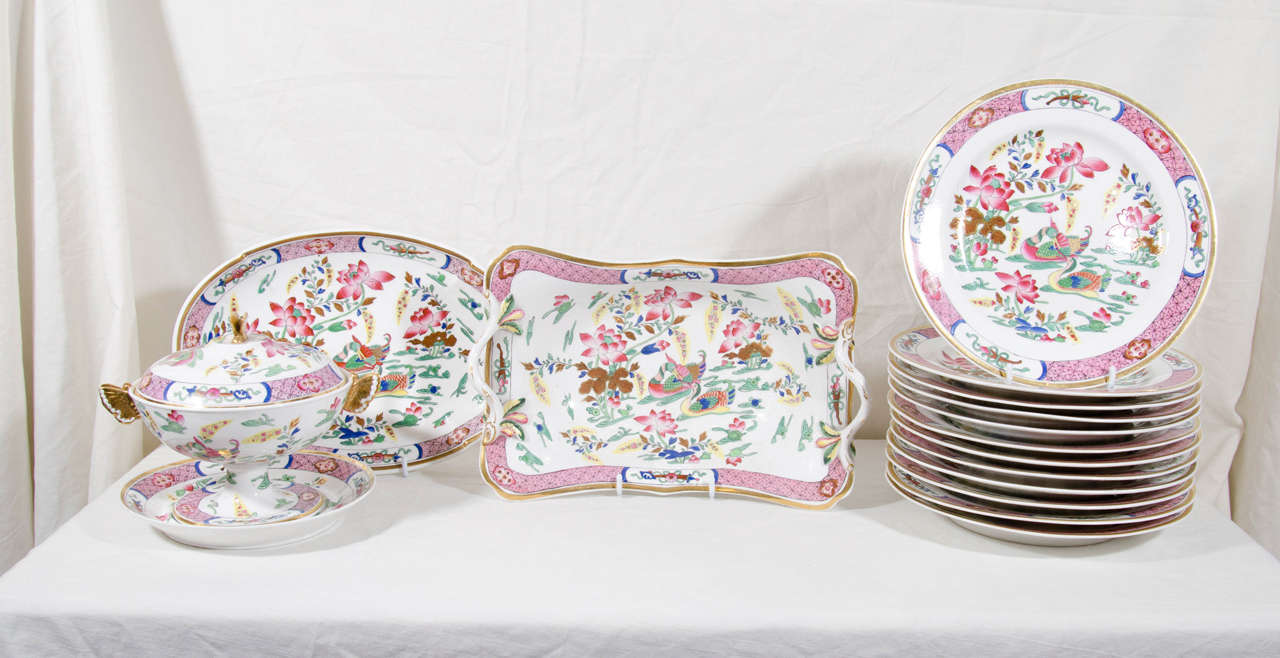 A fine set of Spode dishes painted with lively famille rose colors showing a chinoiserie scene of a pair of mandarin ducks swimming near pink water lilies. In Chinese tradition a pair of ducks symbolizes fidelity, peace and prosperity.
The service