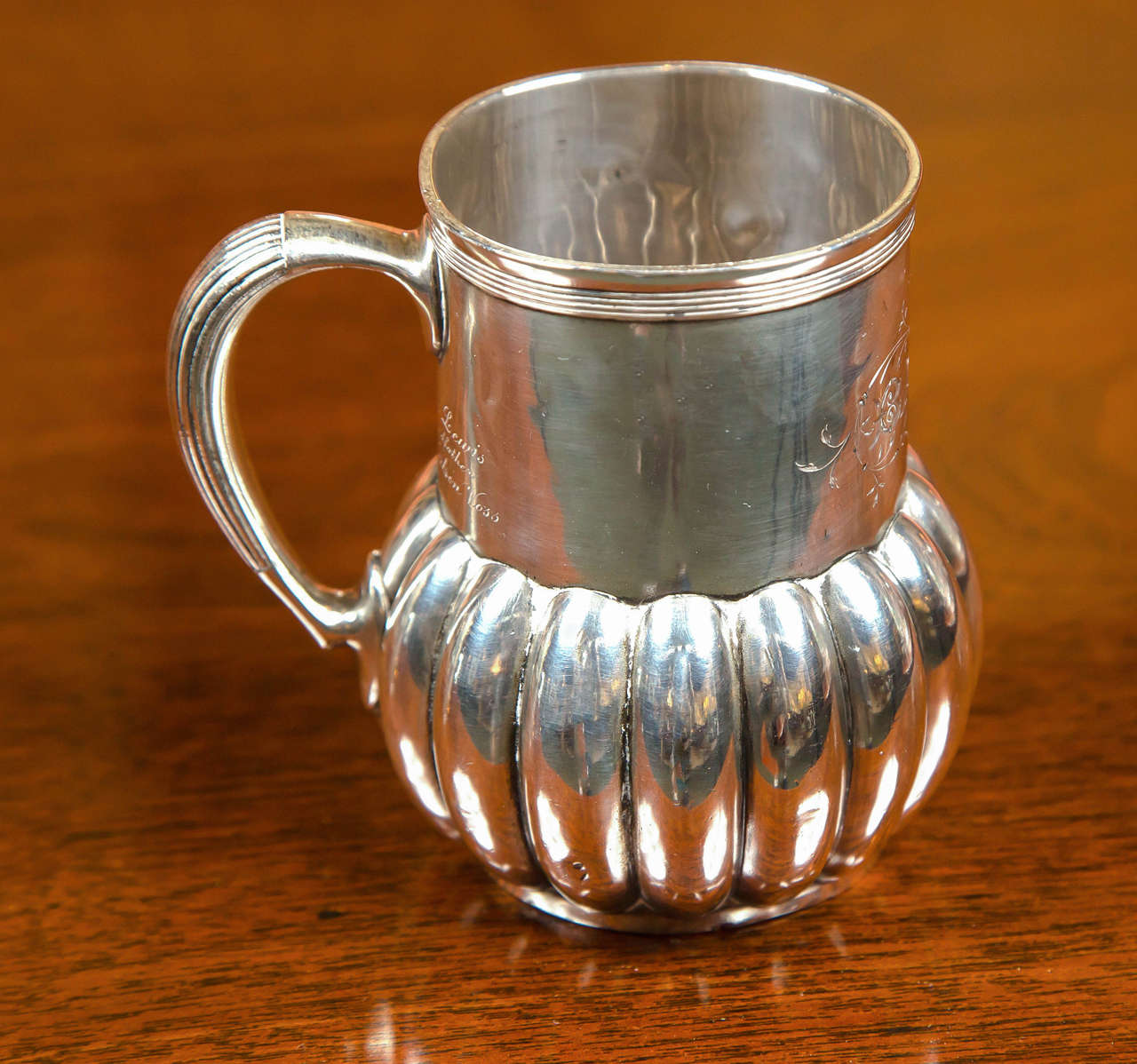 Tiffany & Co. silver cup with engravings.