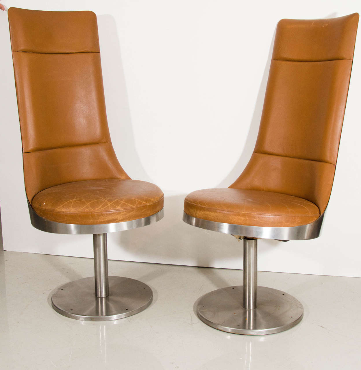 A rare pair of leather and steel chairs by Maria Pergay. We have two pairs.