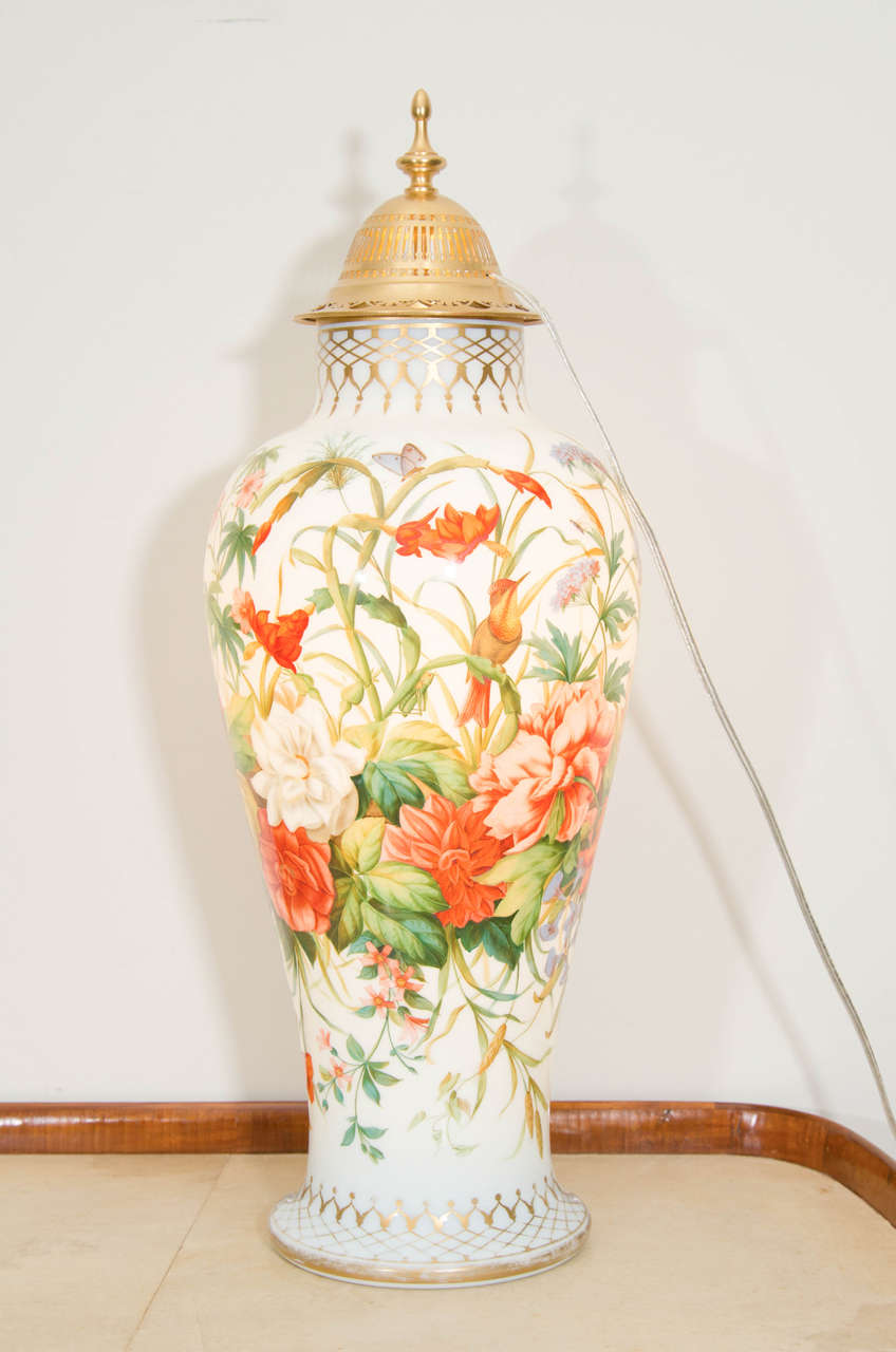 French Baccarat opaline striking vase with colorful green, orange yellow.
Hummingbird and floral pattern, circa 1845. This vase was electrified in the early 20th century by adding a light source in the brass cap.