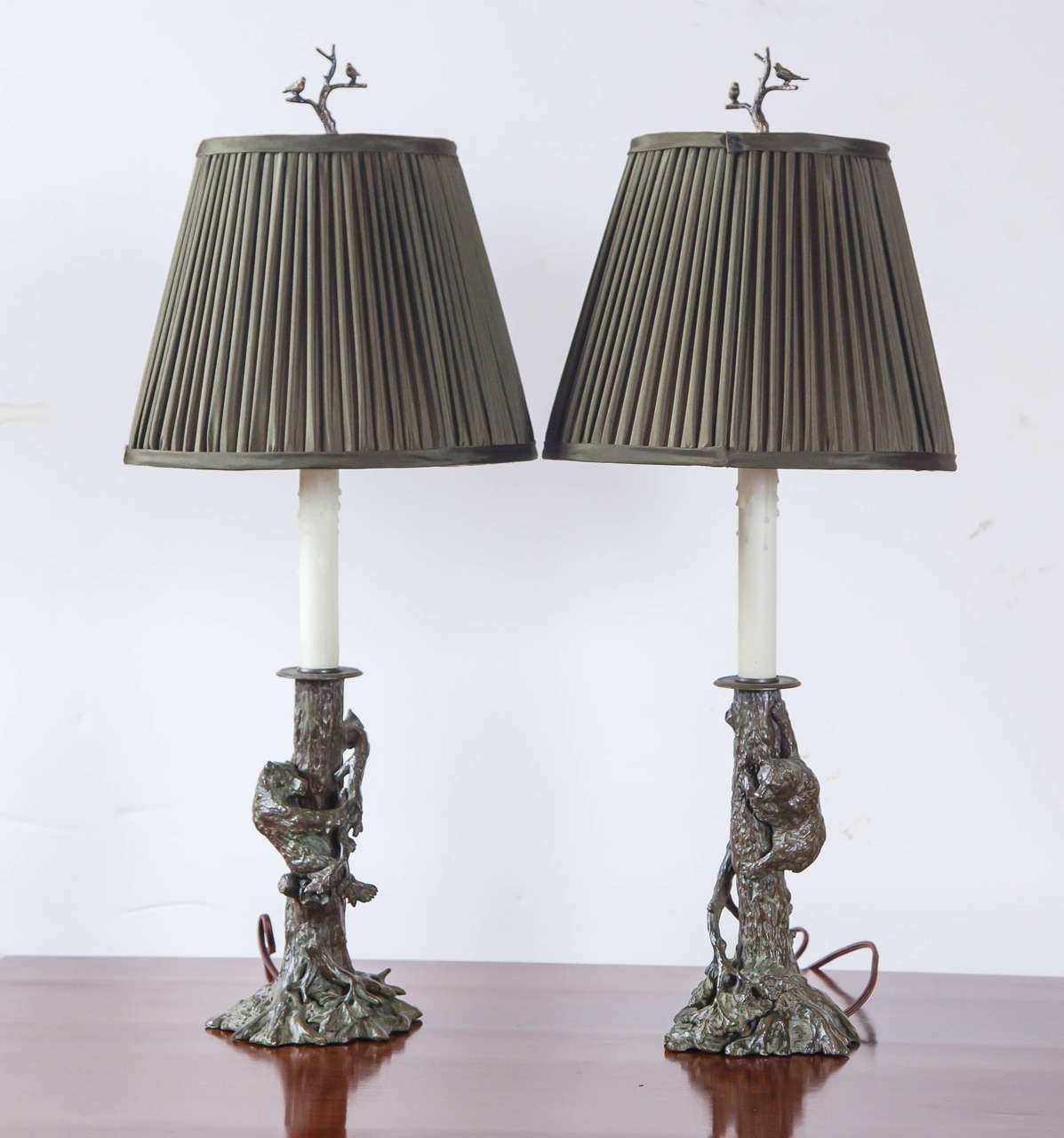 A charming pair of Continental candlestick form bronze lamps. True pair, different presentation. Be sure to see finials!