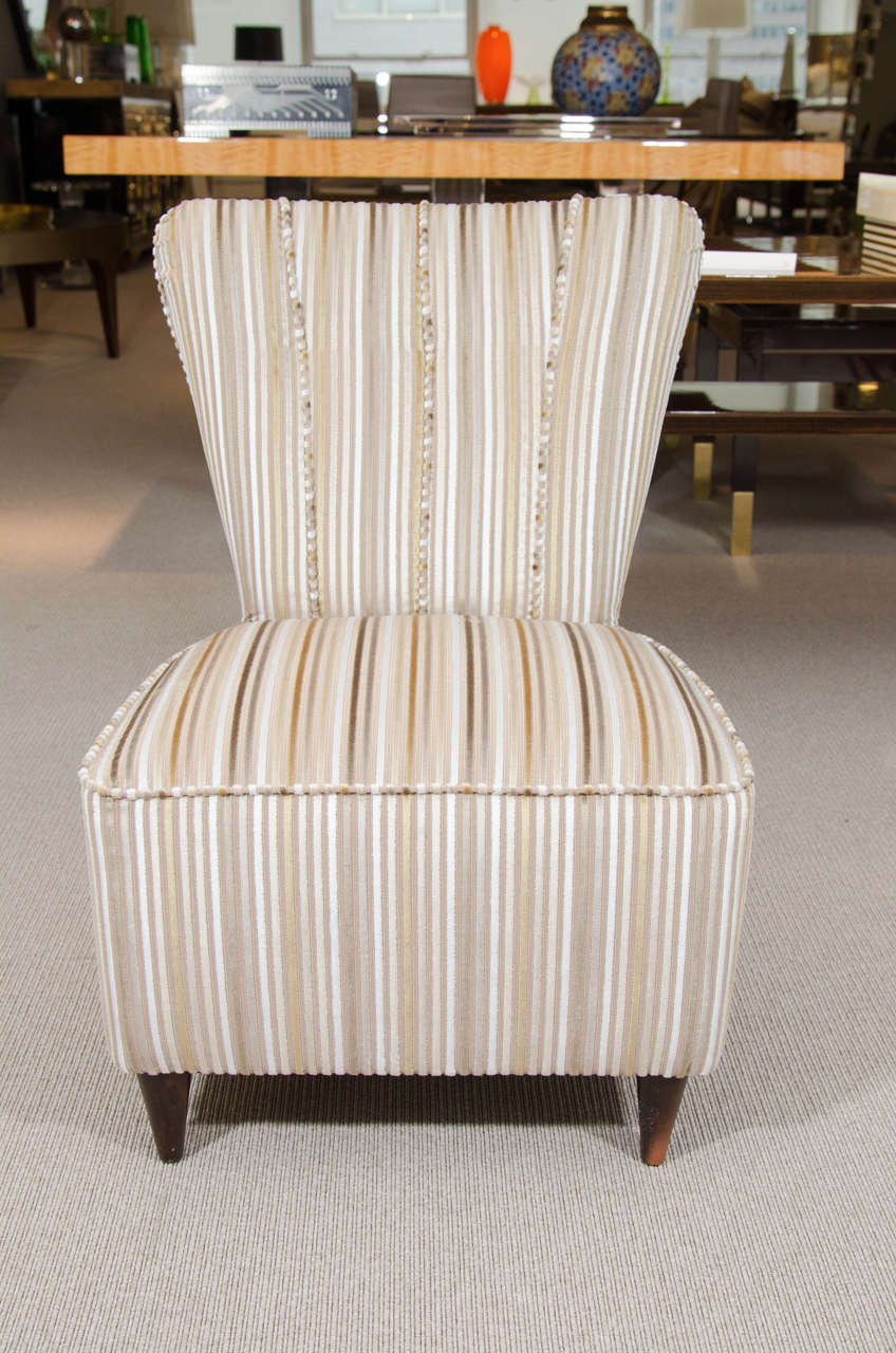 Small, mid-20th century fan-back side chairs with conical wood front feet. Re-upholstered with four channel motif.