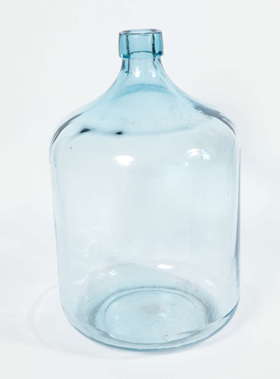 Large glass hand blown jar with blue hue. Various sizes available.