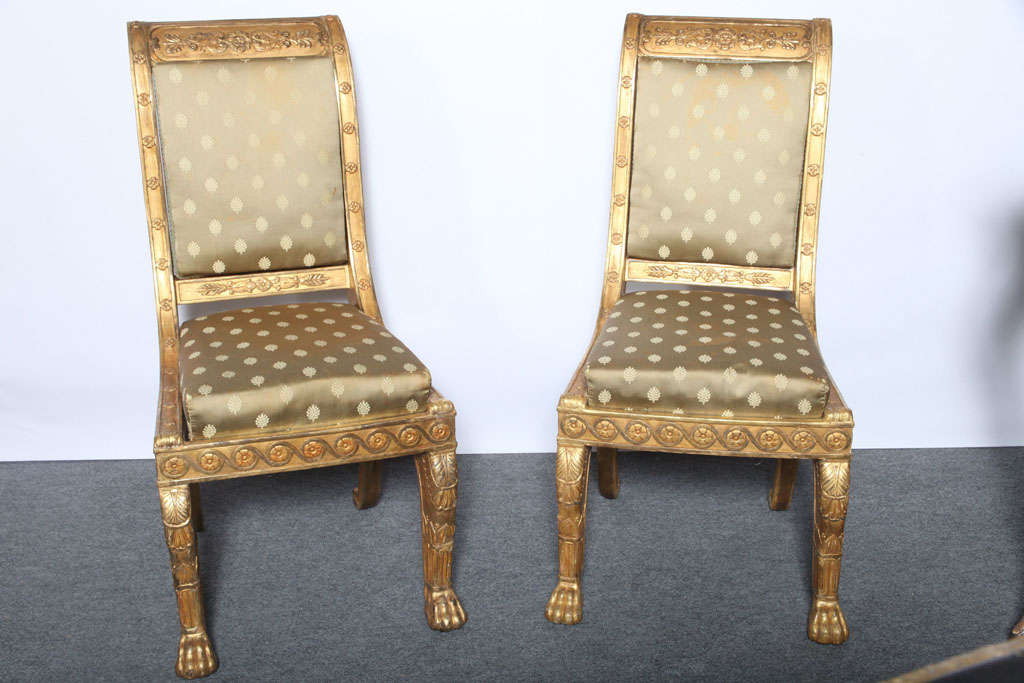 Very fine pair of French Empire giltwood side chairs by Jeanselme, circa 1830, after the antique, in finely carved and gilt wood, with both burnished and matte gilding, in the manner of Jacob, having backs and seats held by steel spring mechanisms,