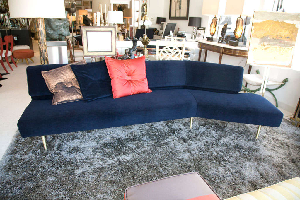 Beautifully restored sofa designed by Edward Wormley for Dunbar Furniture.  This has been reupholstered in a rich blue Wool Velvet with the addition of leather welts.  Six elegant legs are finished in brushed Brass.  The sofa runs approximately 6