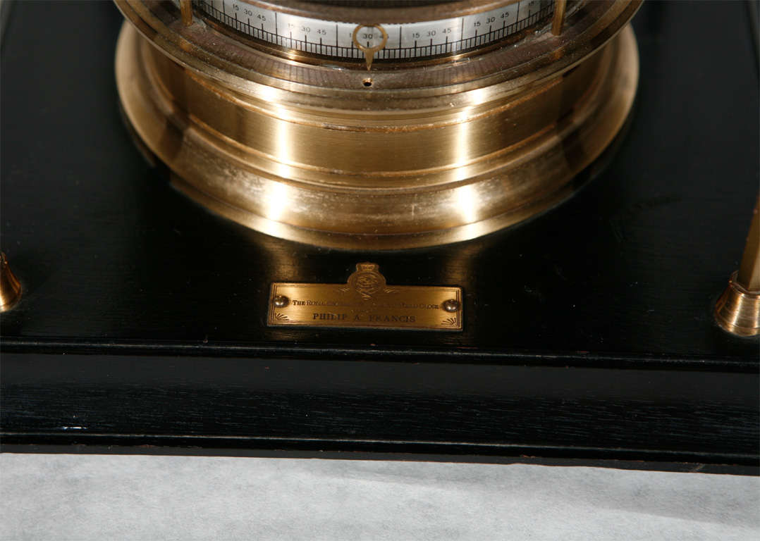 This time piece crafted out of ebonized mahogany and brass embellished with 24k gold was designed by Richard Good for the London Royal Geographic Society in 1979 and features a 15-jewel movement by Swiss clockmaker Arthur Imhof.  Clock is manually