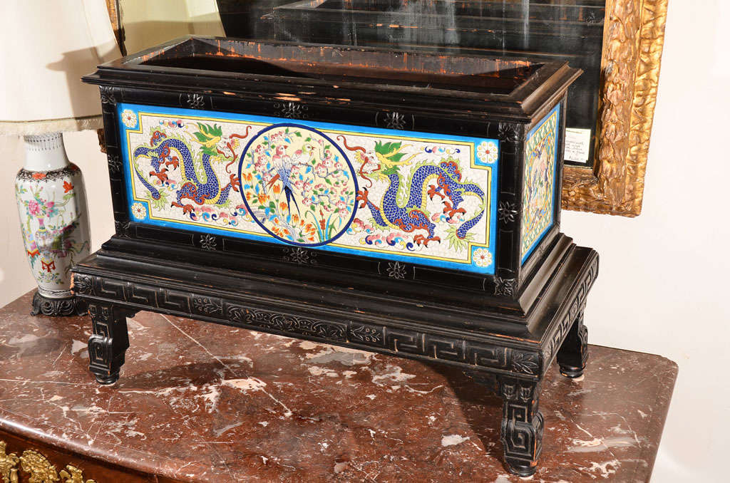 A rectangular planter on stand wood trim and base in the Oriental manner.Tiled on three of the four sides. Stamped Maison Pichenot,J. Loebnitz successeur, Rue des Trois-Bornes No7 et Rue Pierre Levee No 4 Paris. This indicates it was produced