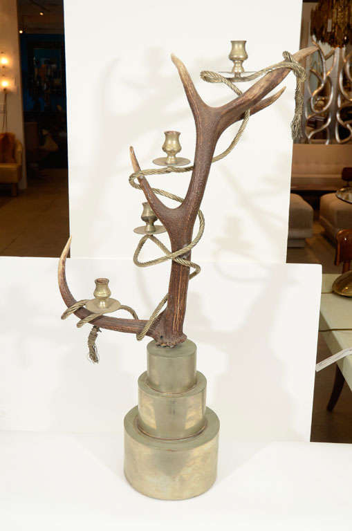 Outrageous and fantastic pair of antler candelabra wrapped in a thick twisted metal rope with wire tassel ends on stacked silver plate platform bases. Minimal wear to bases.