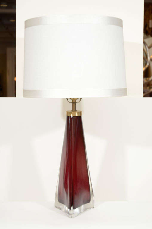 Exceptional pair of Claret glass lamps encased in a thick clear scavvo or sandblasted glass with brass fittings.