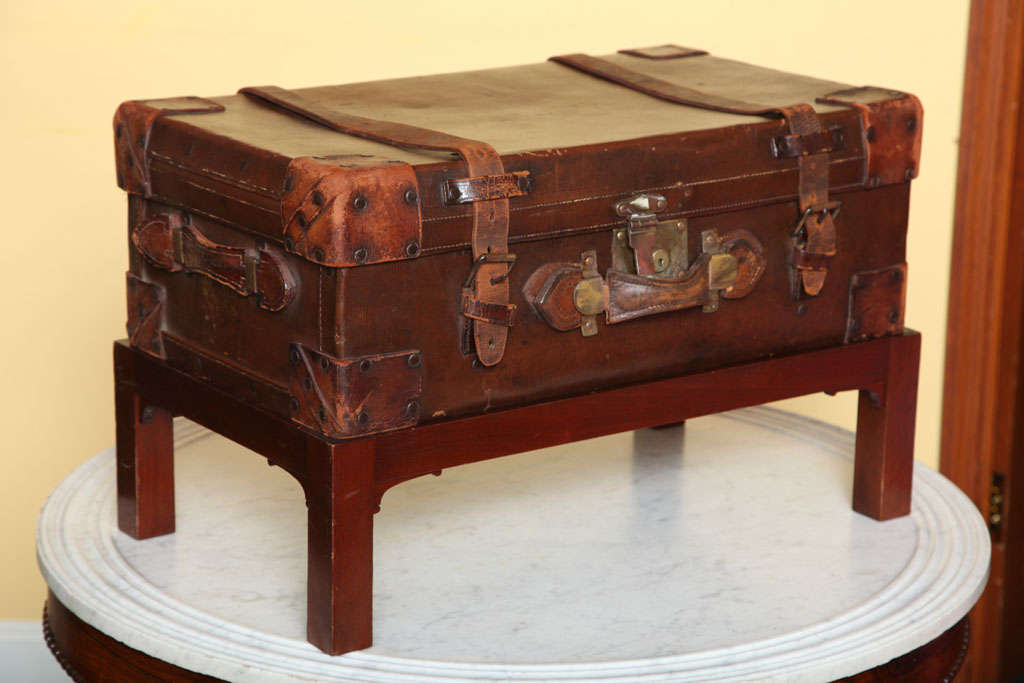 Victorian leather suitcase on later stand, made by Laversuch Of South Sea, UK