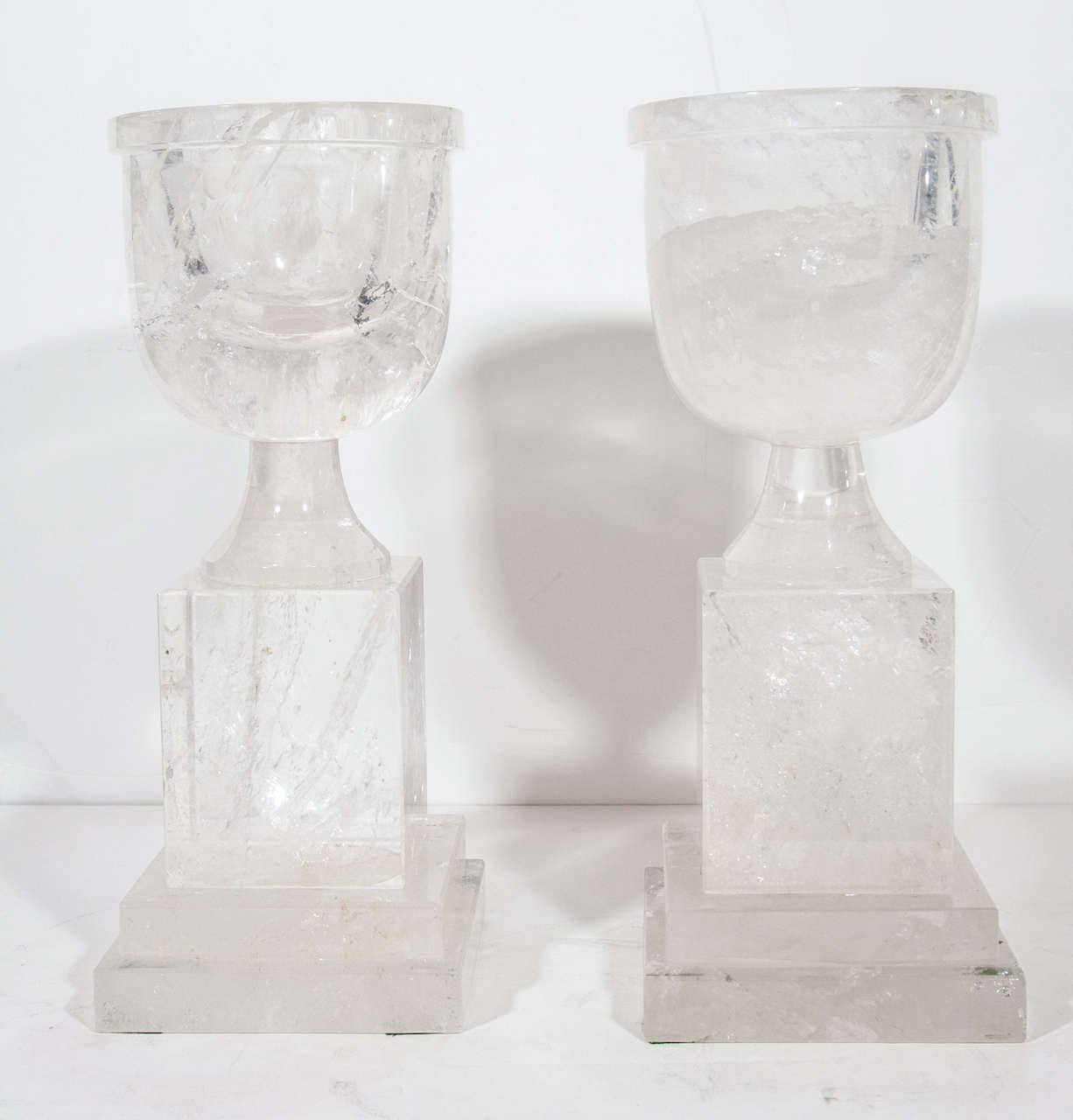 A pair of superb and very unusual Art Deco style cut rock crystal urns of fine quality.