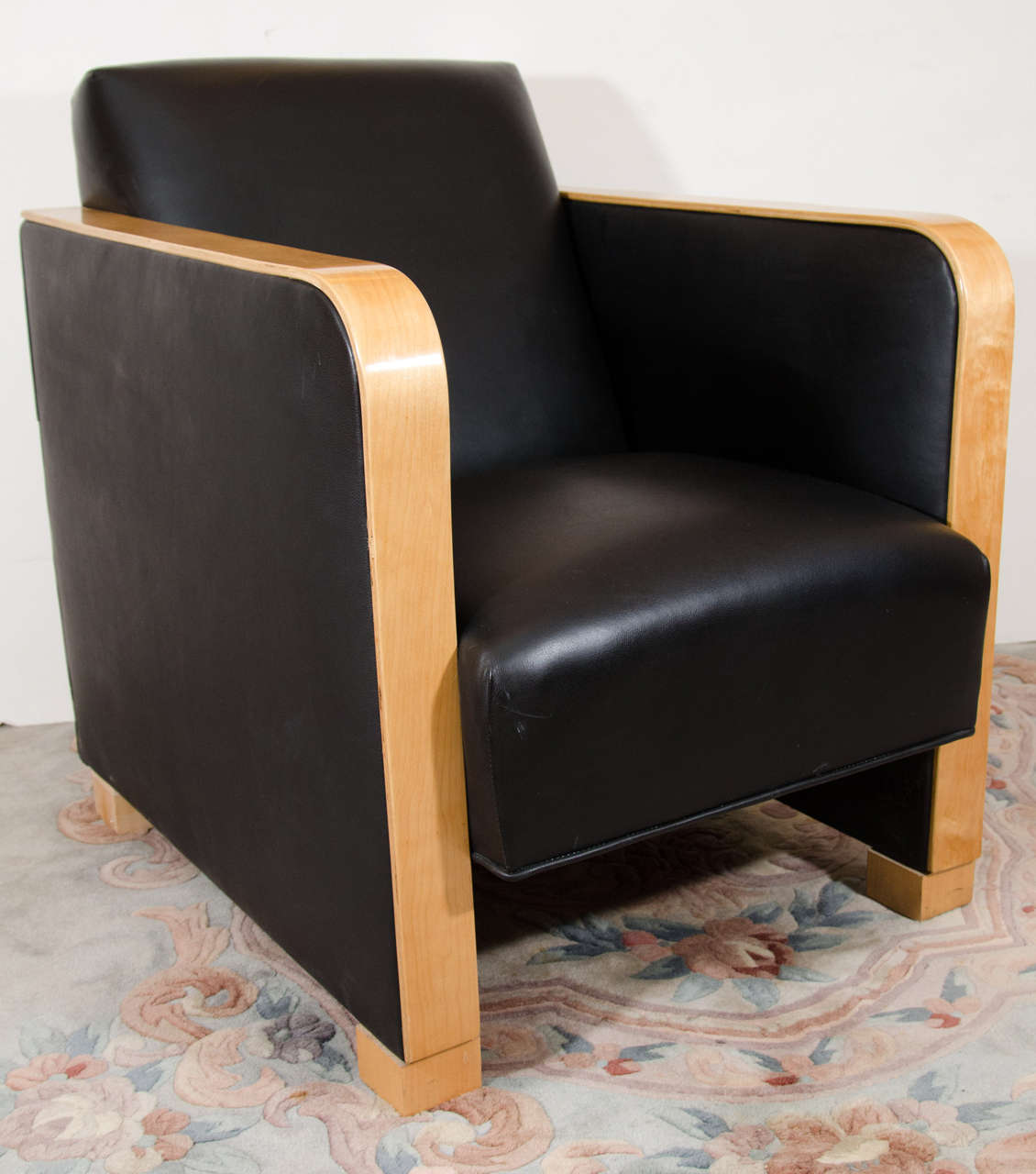 An oversized club chair with a strong masculine frame, crafted of solid and bent birch and upholstered in tough, black motorcycle leather.