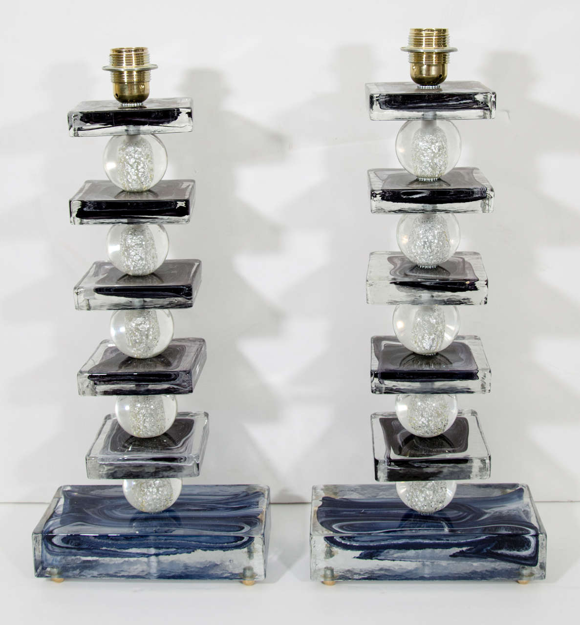 A most unusual pair of Murano glass column lamps composed of midnight blue over white glass cubes and round clear glass globes with silver leaf inclusions. These one of a kind lamps that are truly works of art. The height listed is to the top of the