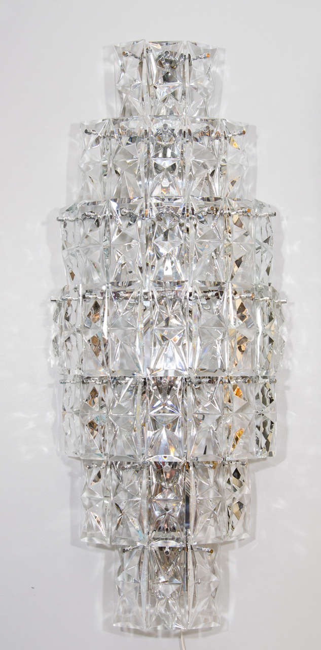 A pair of spectacular sconces attributed to the Austrian glass company, Lobmeyr. Made up of seven tiers of hanging faceted glass. Their size makes these sconces unusual and stunning.