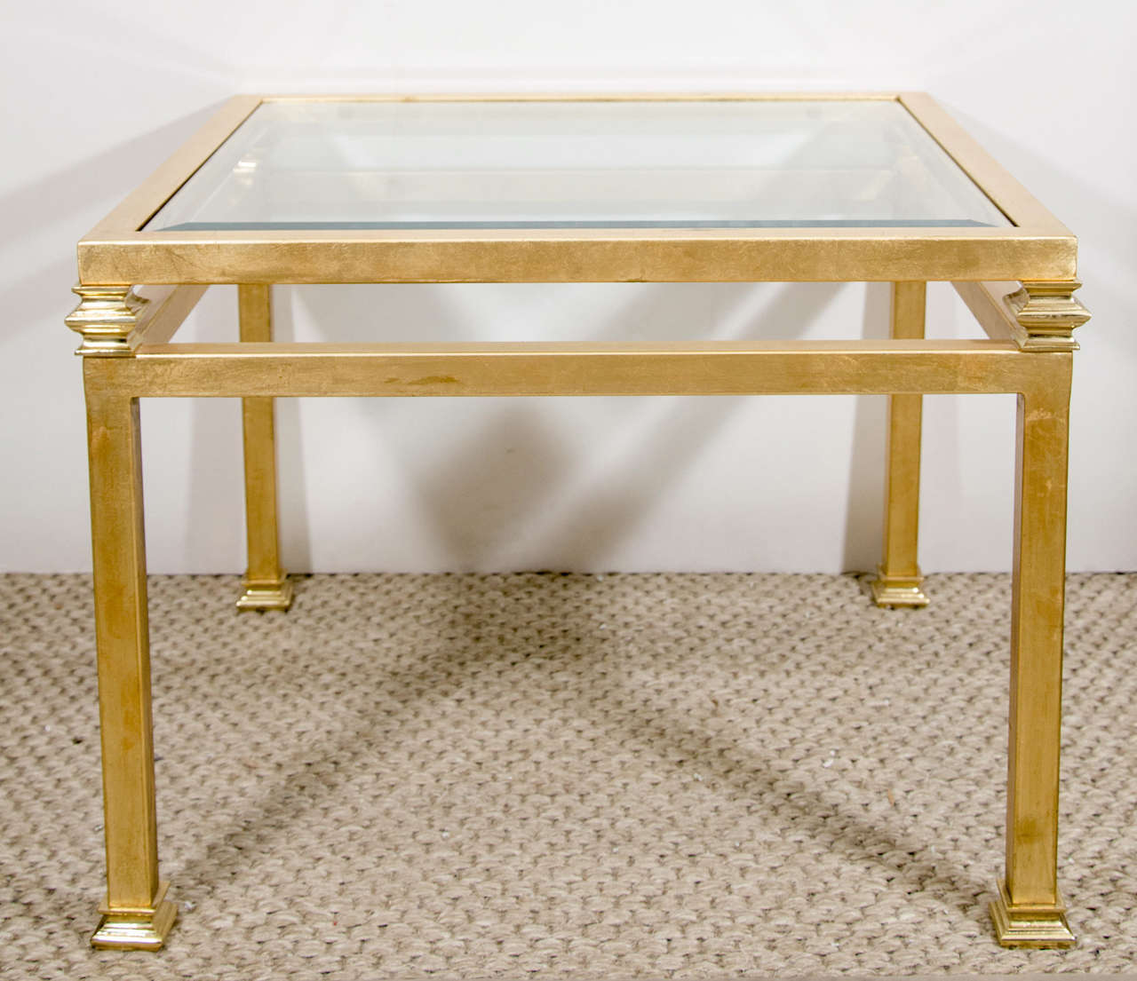 A very striking pair of gilt iron side tables with lovely detail on the legs and beveled glass top. France, circa 1960s.