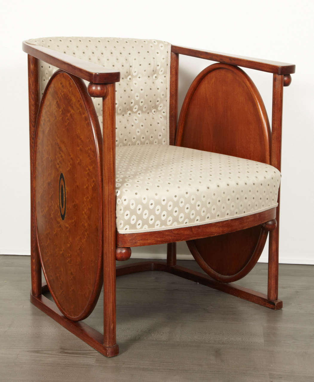 Koloman Moser (1868-1918) and Josef Hoffmann (1870-1956).
Bent and polished beech and plywood, dyed to rosewood, brass inlays, renewed upholstery.
Measures: Height 70 cm (27.5 in.), width 73 cm (28.7 in.), depth 66 cm (26 in.).