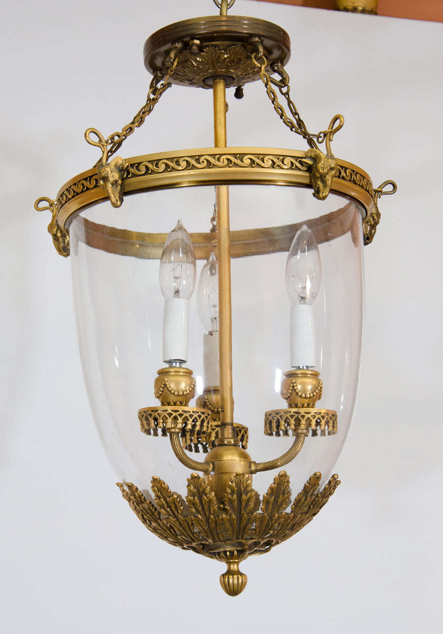 A Fine Regency style gilt bronze three light hall lantern decorated with rams heads, vitruvian scroll work, tassell's and acanthus leaves.