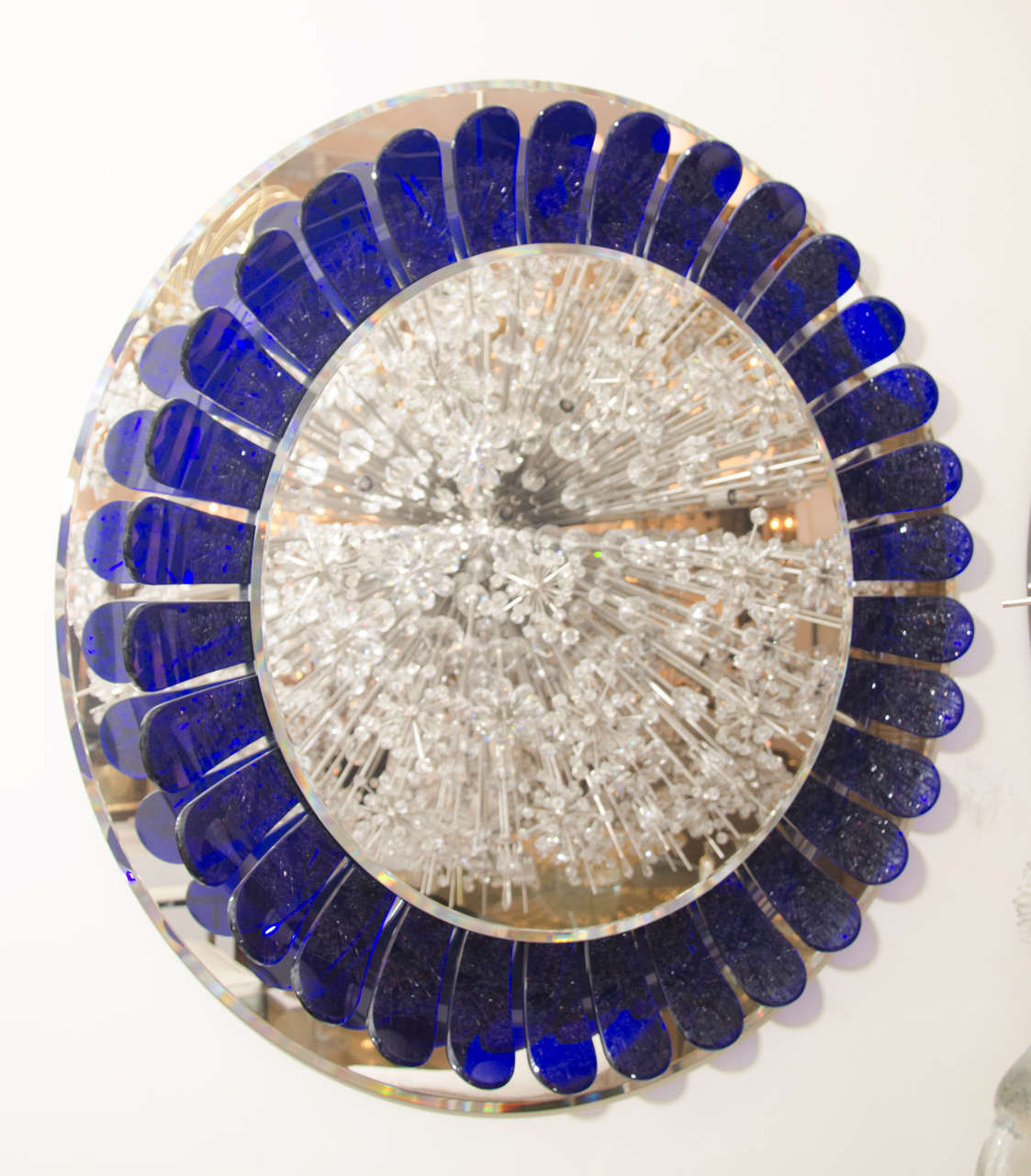 Large circular flower form mirror with curved cobalt blue glass element surround.

View our complete collection at www.johnsalibello.com