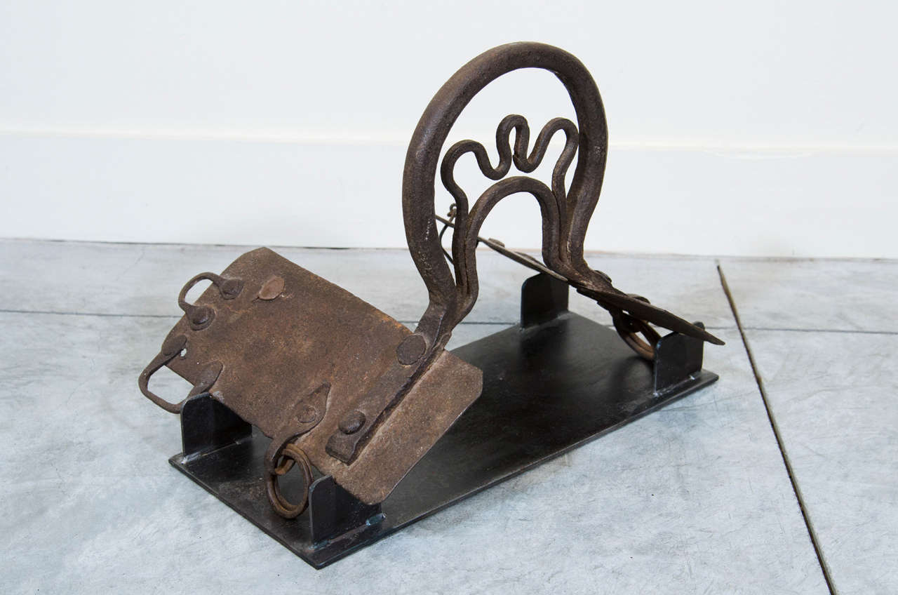 A hand wrought 19th century Chinese cast iron saddle mounted on custom stand. Shanxi Province, c. 1850.
M882