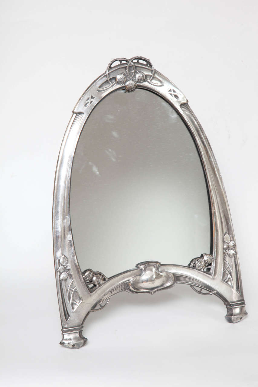 A great period secessionist vanity standing mirror in polished pewter by the firm WMF with hall marks on leg.