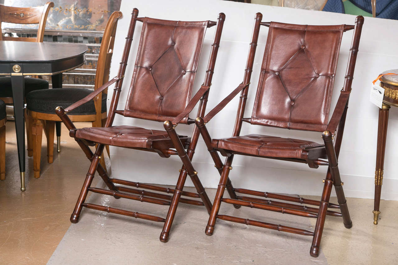 Set of ten Bamboo Form Folding Chairs. Each in a fine button tufted brown slightly distressed leather seat and backrest. All brass joints as well as brass finials decorated and support this soft leather chairs. These chairs are all handmade and