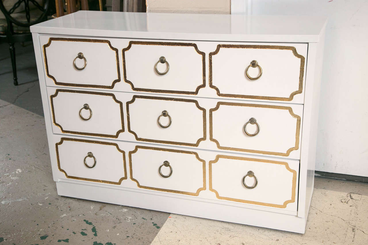 Dorothy Draper style three-drawer commode exquisitely detailed with one of Dorothy's favorite color combinations, satin white and gilt gold highlights! Representing 
