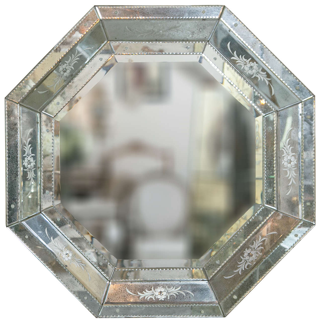Pair of Venetian style Hollywood Regency mini octagon mirrors. These beautifully etched glass antiqued framed mirrors having several outer design frames over a central octagonal beveled mirror. The backs supported with wood and heavy metal hanging