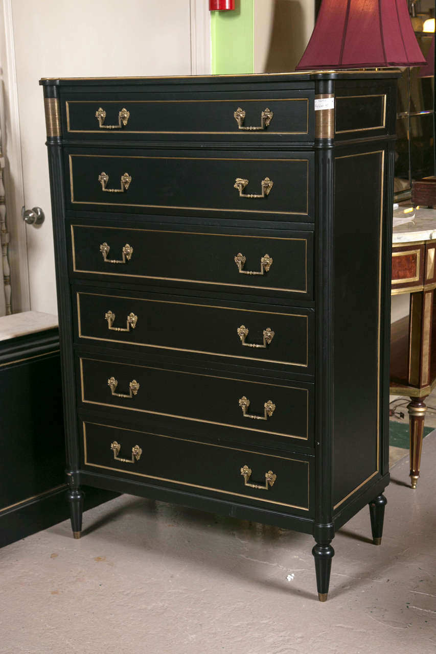 Ebonized high chest extraordinaire! The detail on this piece is aesthetically clean lined and pleasing in every sense of the word. The six-drawer chest is a welcome addition to any space. The bronze mounts applaud the fluted corners and add a