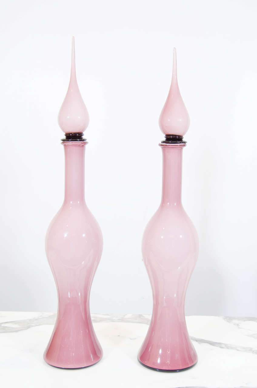 Pair of cased glass decanters in a beautiful color and form. The color is difficult to capture in photos and is actually more lavender, less pink. Please contact for location. 