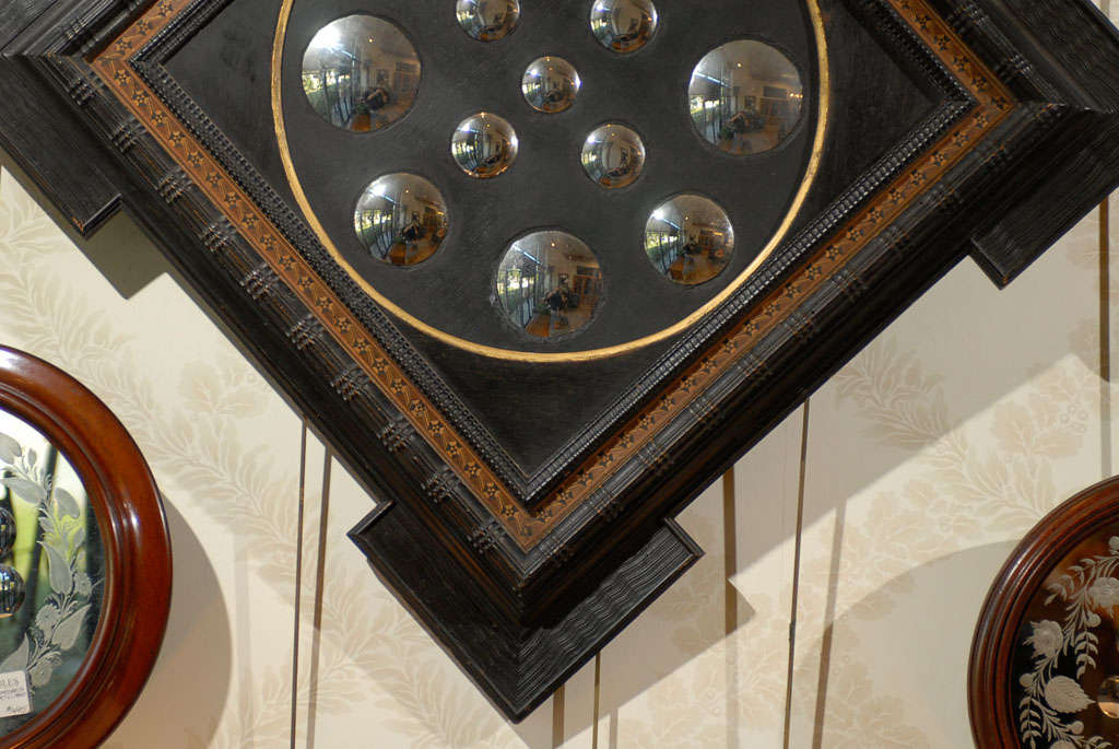 Crystal balls, gazing balls and mirrors have been used  as mystical items down through the ages from Nostradamus to Harry Potter. In this case, the mirror is meant to distort the reflection by embedding small convex mirrors in the surface reflecting