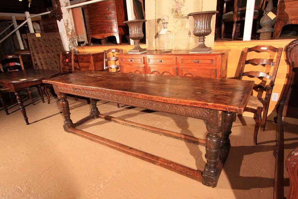 Italian Elm Monastery Table<br />
<br />
This hard to find table has a thick two board elm top with wonderful petina and character.<br />
<br />
The apron is hand-carved on three sides with the back left uncarved. This would indicate placement