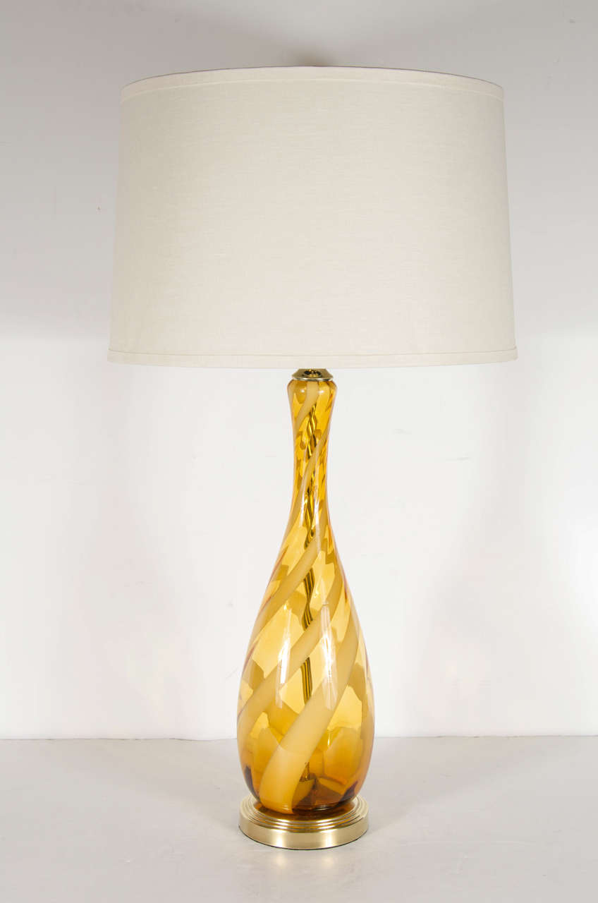 Mid-Century Modernist table lamp comprised of hand-blown Murano glass in a teardrop shape. This lamp is featured in a dark, smoked Amber. The stripes that follow the lamps curvature alternate in clear and opaque smoked Amber giving it great
