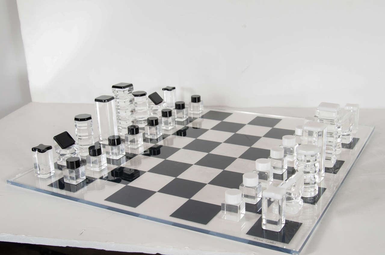 This gorgeous set is made of black and white and clear thick lucite chess pieces with a board as well. This set is signed by Rona Cutler as well. It would be great with the lucite and glass game table we have in inventory