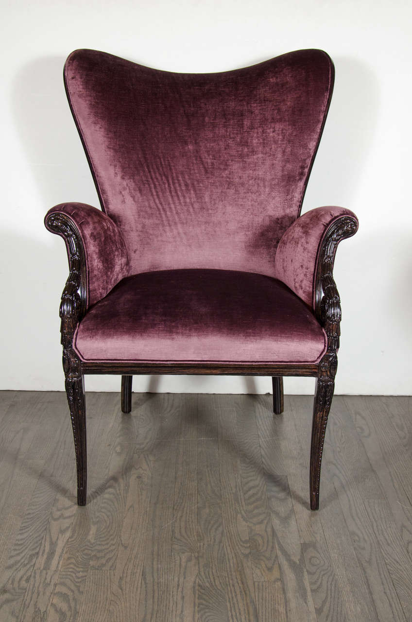 This elegant pair of wingback armchairs was realized by the illustrious American maker Grosfeld House- where legendary designers such as Vladimir Kagan and Lorin Jackson refined their craft, circa 1940. They feature hand-carved acanthus style